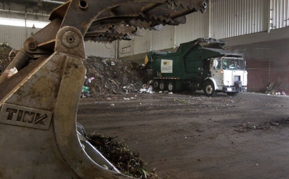 A truck unloads compostable
