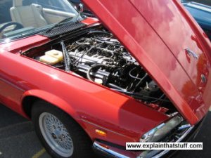 A red Jaguar XJS sports car with the bonnet/hood open