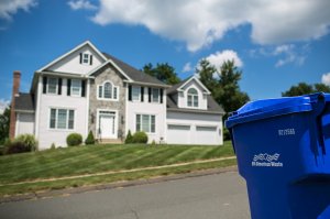 Blue recycling bin outside of a home